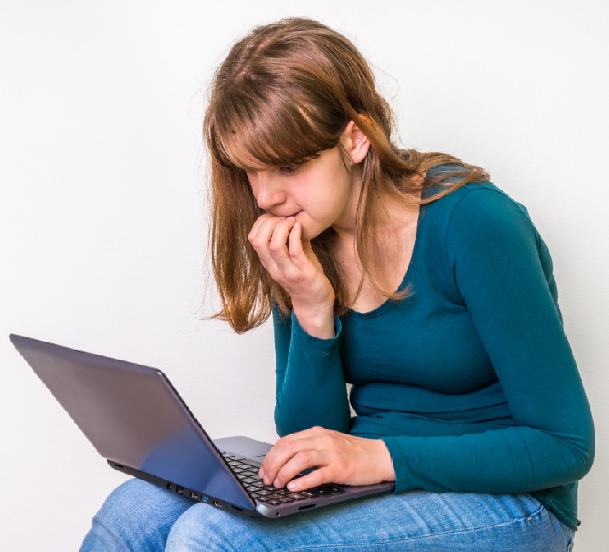 Woman slouched over laptop